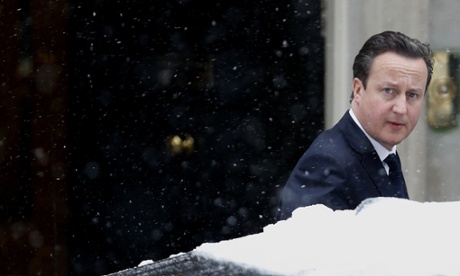 De Britse premier David Cameron verlaat Downing Street 10 in de sneeuw.