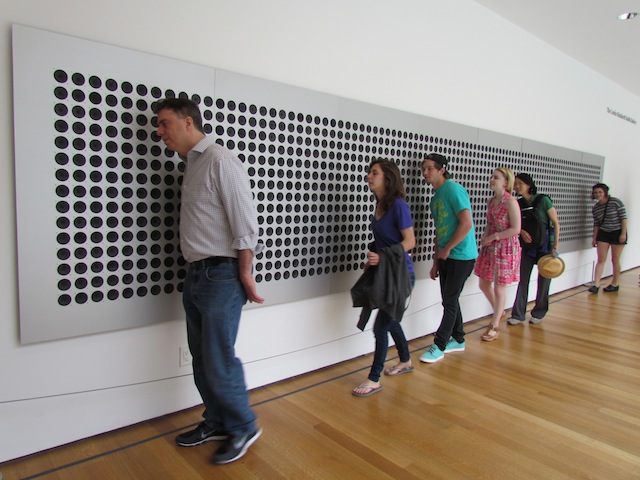 Bezoekers van het MoMA luisteren naar 'Microtonal Wall' van Tristan Perich.